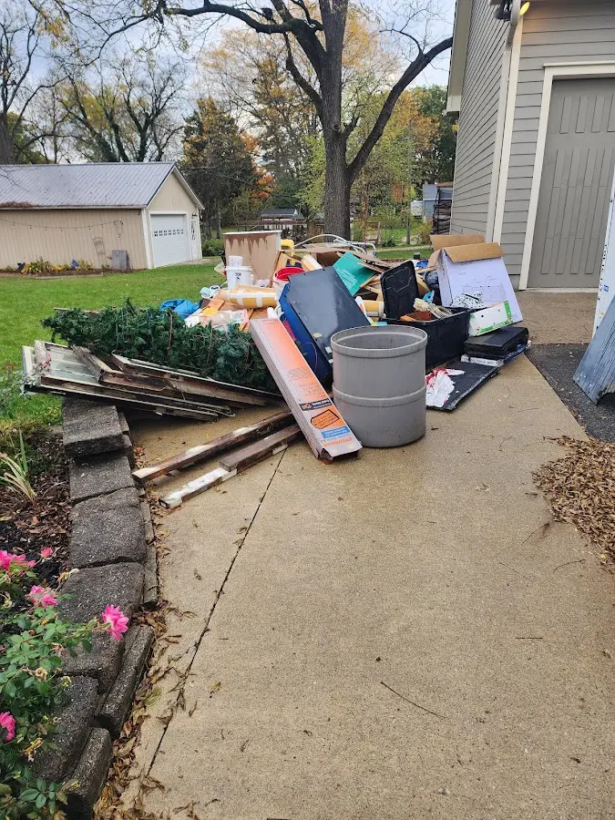 Dumpster being loaded with debris for Estate Cleanout Dumpster Rental in Ely